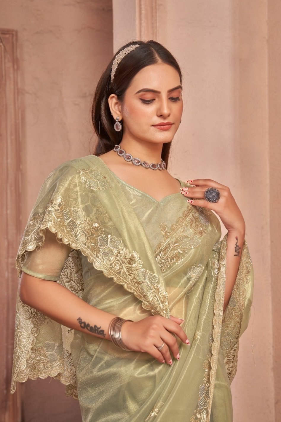 Chic Shimmer Net Saree Adorned with Swarovski Stones and Embroidered Patterns